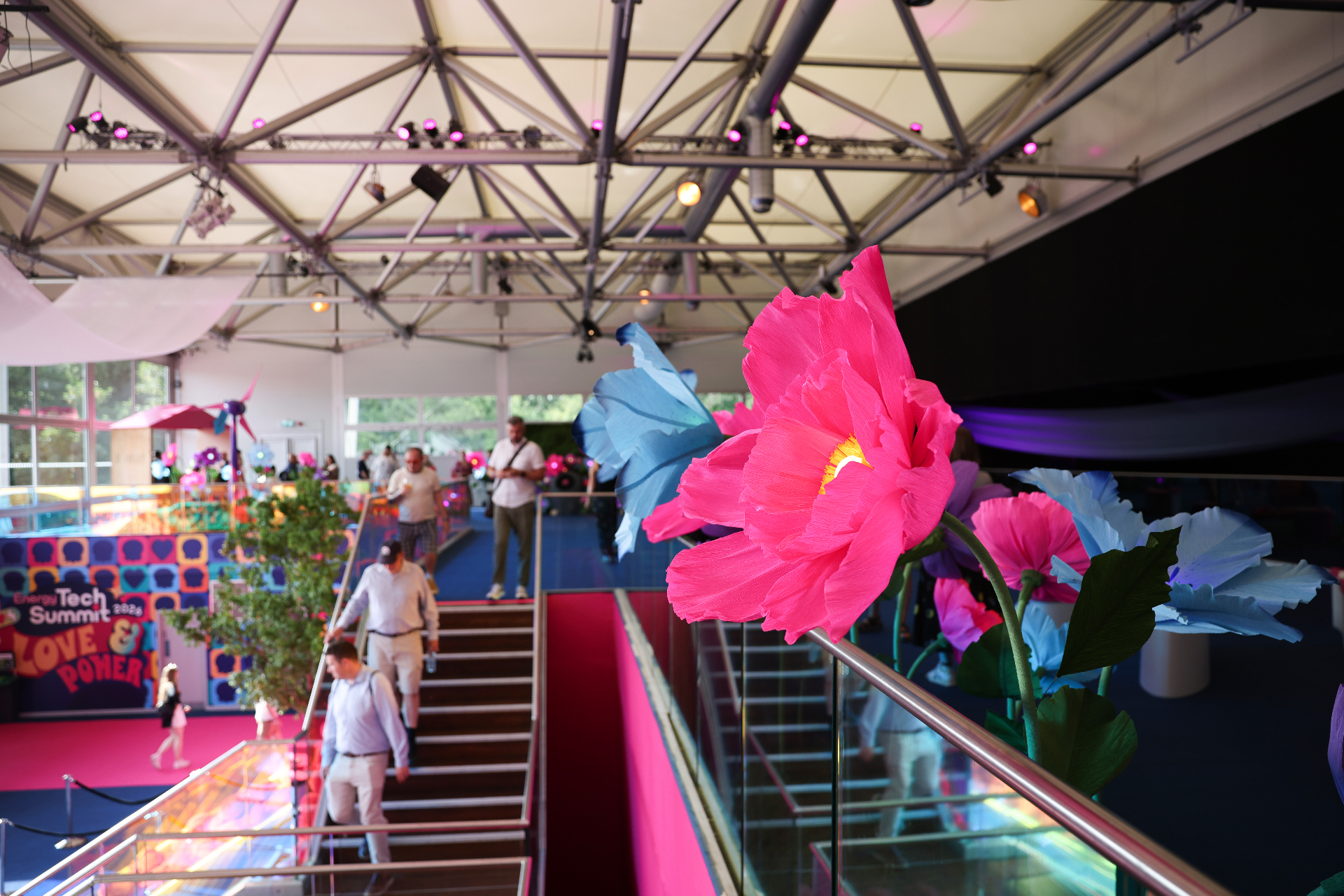 Show floor scenography with oversized paper flowers