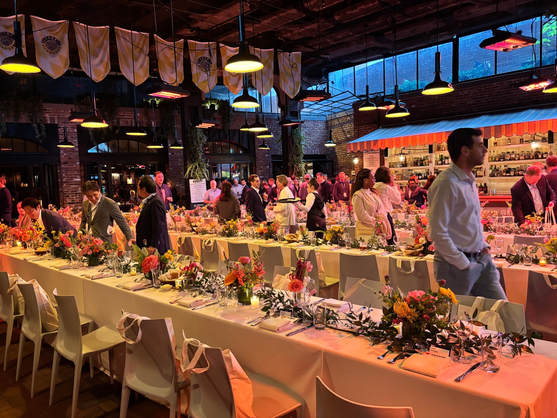 Long-table delegate dinner during Impact with floral tablescape and international guests
