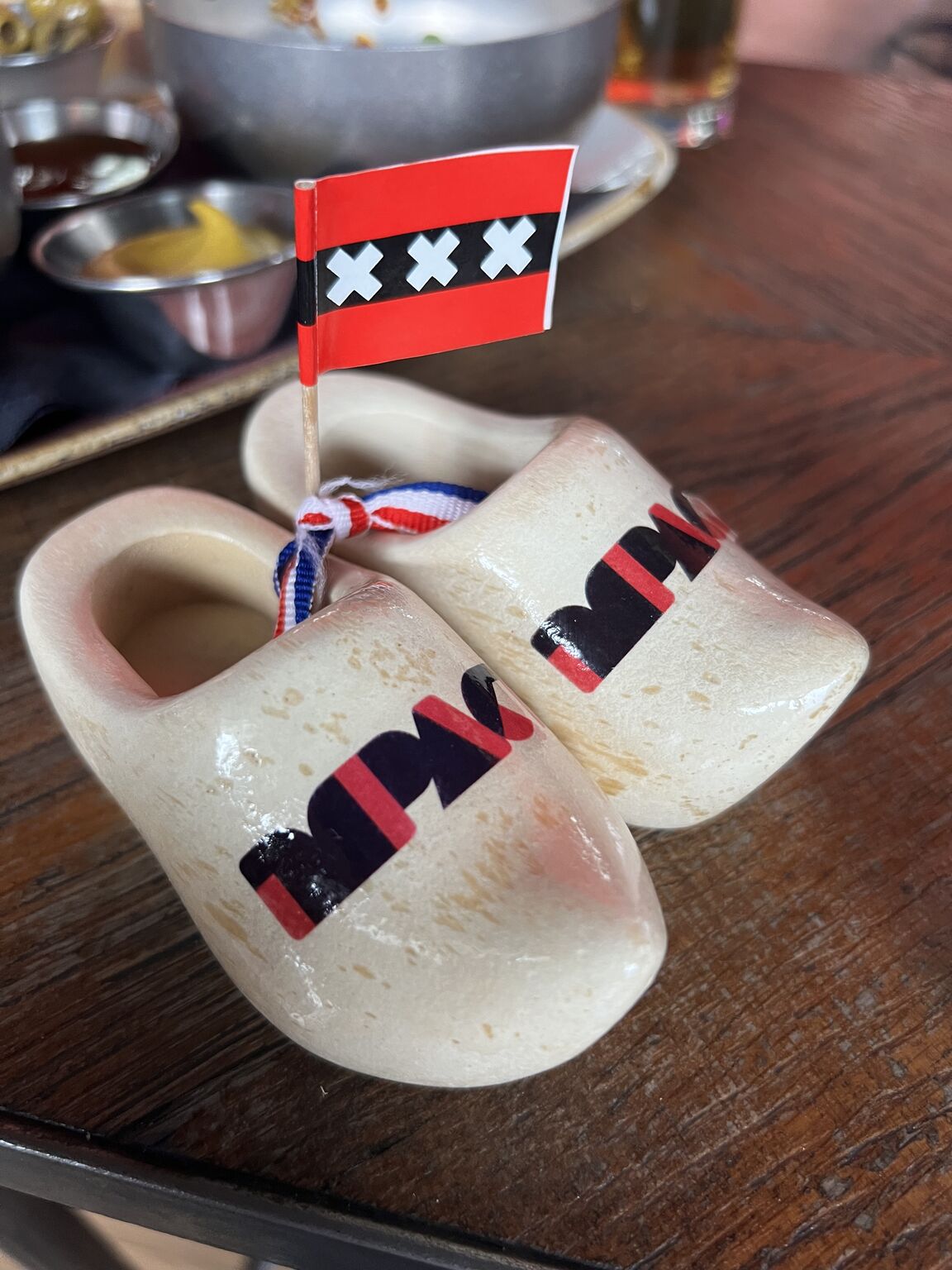 Miniature Amsterdam clogs branded with Impact on a dinner table